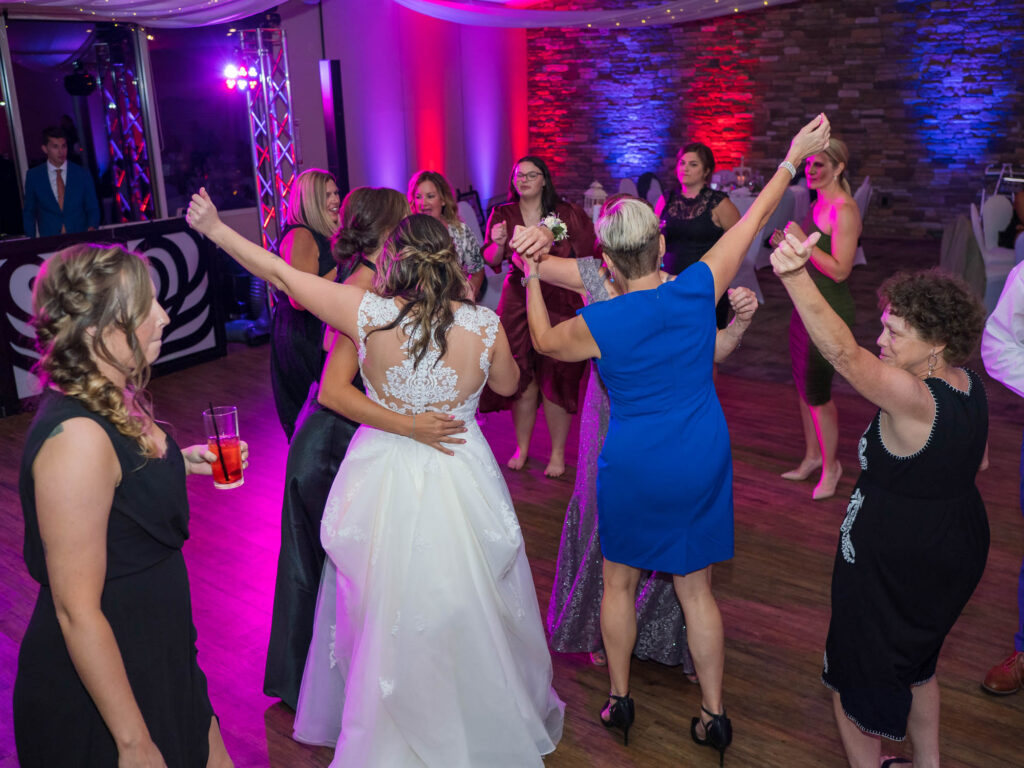 Multi-color uplighting on wedding dancefloor at woodstone country club & lodge