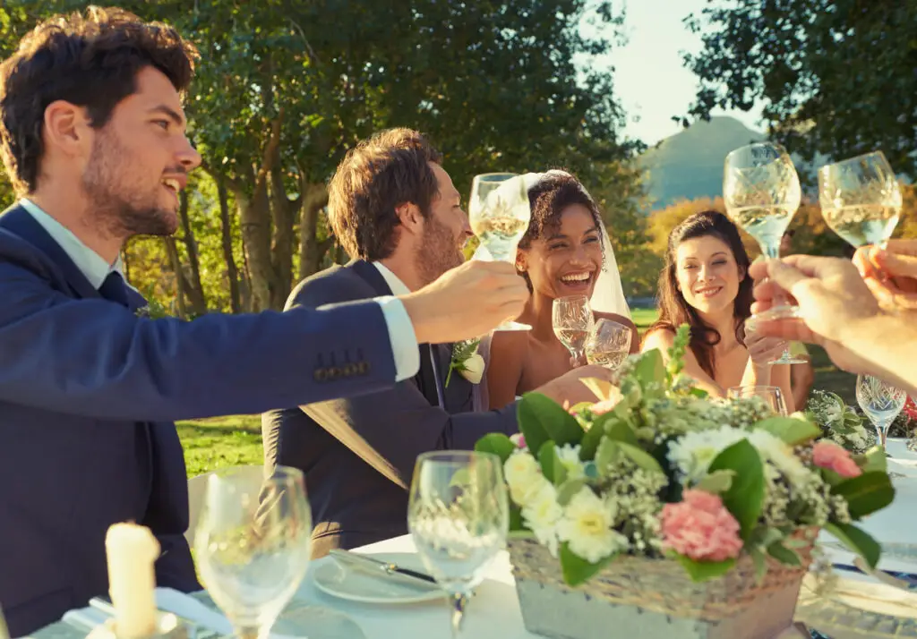 Guests toasting the bride and groom at a wedding